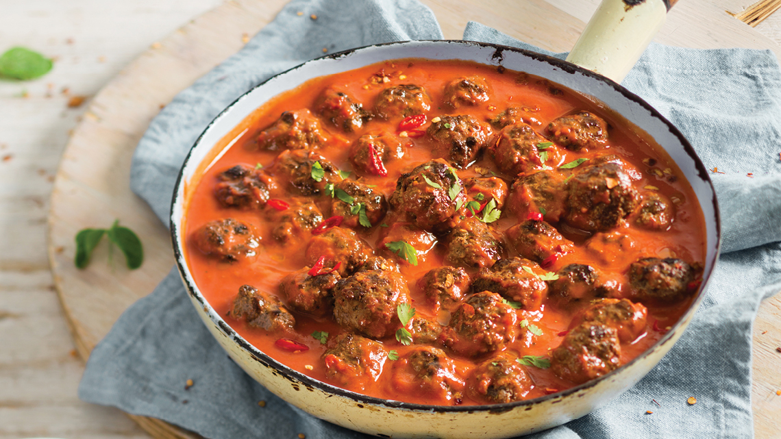 Beef Kofta Balls in a Spiced Tomato and Yoghurt Sauce Served on a Bed